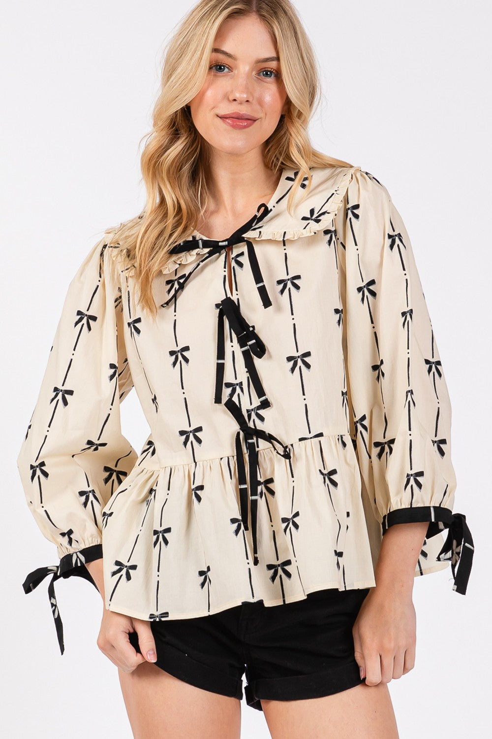 SAGE + FIG Bow Print Tie Front Ruffle Hem Relaxed Fit Babydoll Blouse | Cream